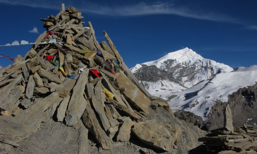 Cairn on Summit of Tharong La high pass on Annapurna circuit trek in the Nepal Himalaya