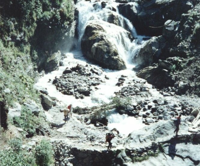 Crossing beneath a waterfall on a side-stream