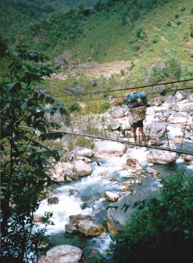 Nepalese Porter crossing Suspension Bridge across Kabeli Khola to Yamphudin