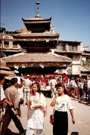 Nepalese girls and pagoda-style temple at Asan Toll