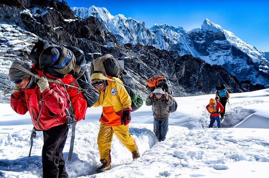 Nepalese trekking porters crossing Cho La