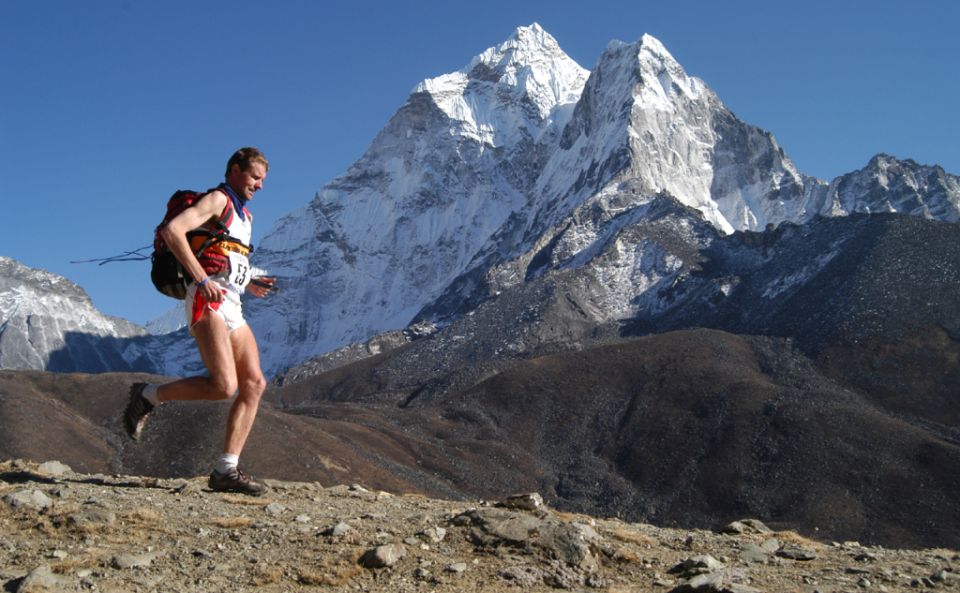 Everest Marathon runner beneath Mount Kang Taiga on route to Namche Bazaar