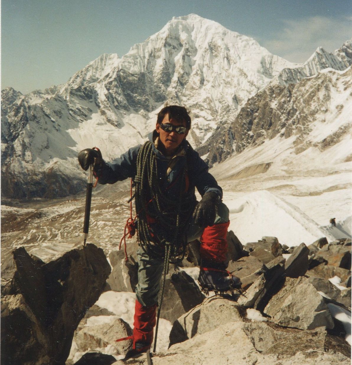 Nima Gyalzen Sherpa on summit of Yala Peak with Langtang Lirung in background