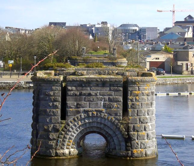 Remains of old railway bridge over River Corrib in Galway on West Coast of Ireland