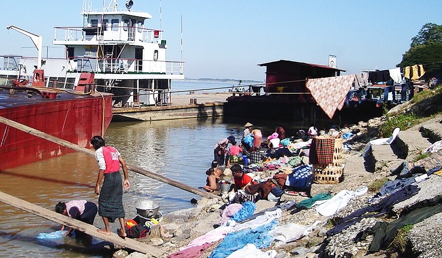 Washing Day on the banks of the Irrawaddy River at Mandalay in northern Myanmar / Burma