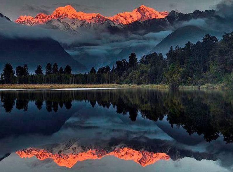 Mount Tasman and Mount Cook from Matheson Lake near Fox Glacier Town on the South Island of New Zealand