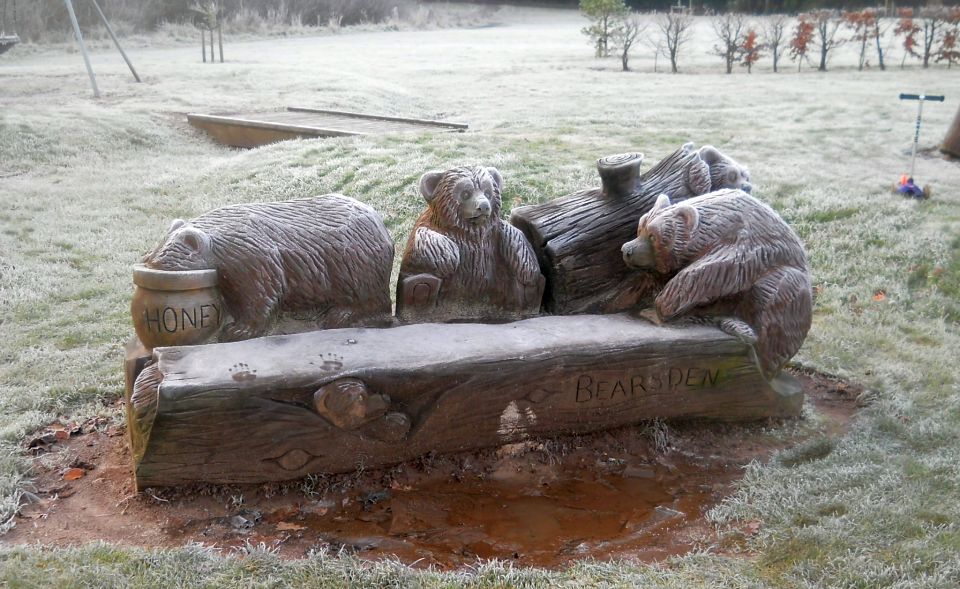 Carved beech bench in playing field at Stockiemuir Avenue