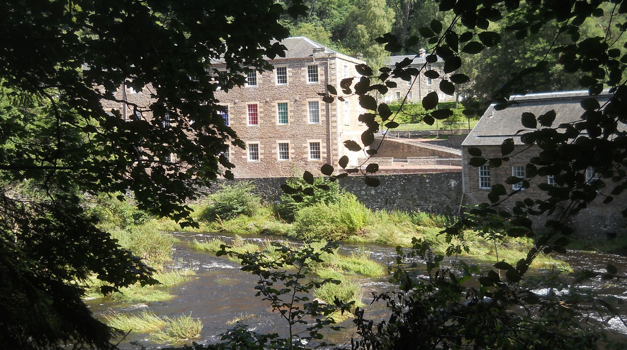New Lanark from trail to the Falls of Clyde on the south side of river