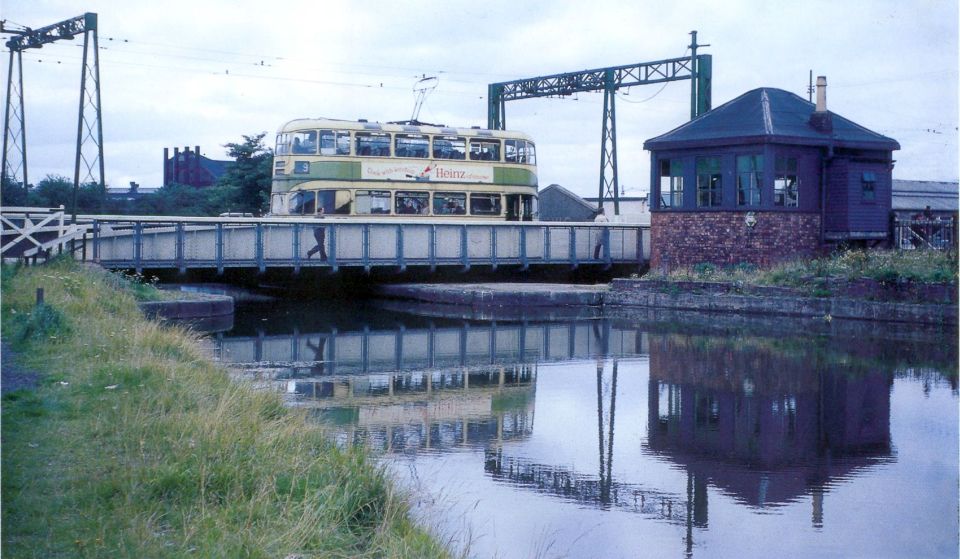 Tram crossing former swing bridge over the Forth & Clyde Canal in Dalmuir