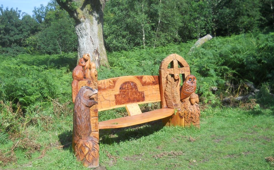 Carved wooden bench in Killearn Glen
