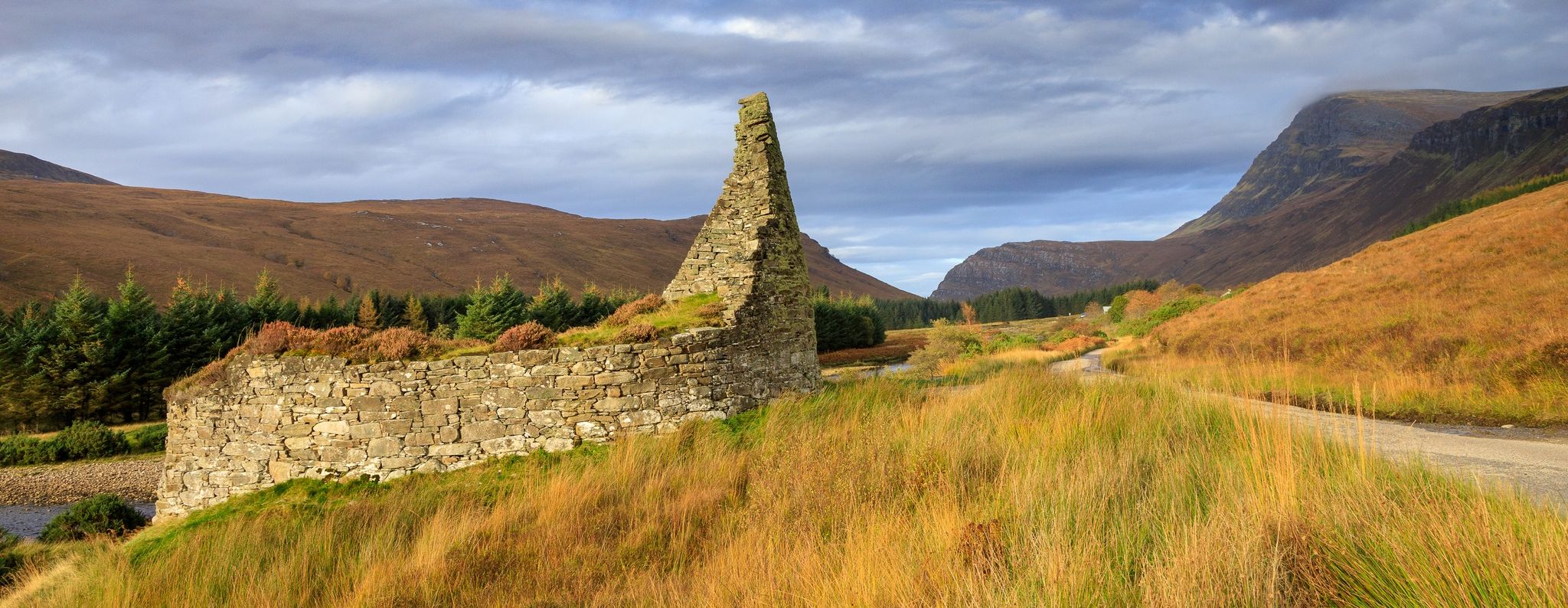 Ben Hope and Pictish Tower ( Broch ) of Dun Dornaigil at trailhead for Ben Hope in Highlands of Northern Scotland