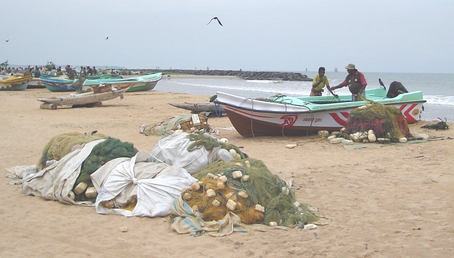 Fishermen and Boats on the beach at Fishing Village in Negombo