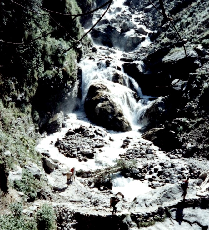 Crossing beneath a waterfall on a side-stream