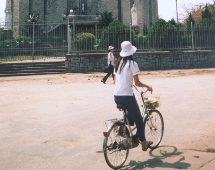 Vietnamese girl cyclist in Hue