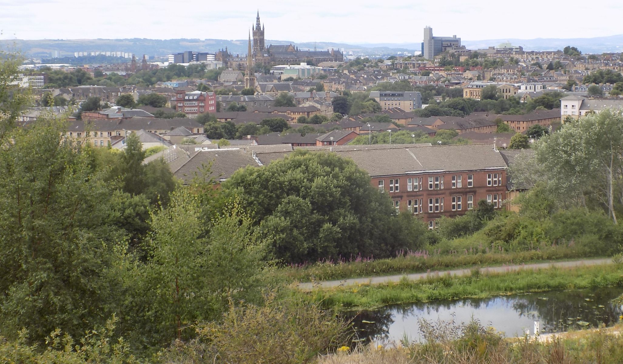 Tower of Glasgow University across the Forth and Clyde Canal from the viewpoint in Claypits Nature & Wildlife Reserve