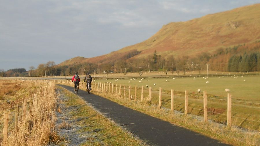 Cyclists on the Strathkelvin Railway Path beneath the Campsie Fells